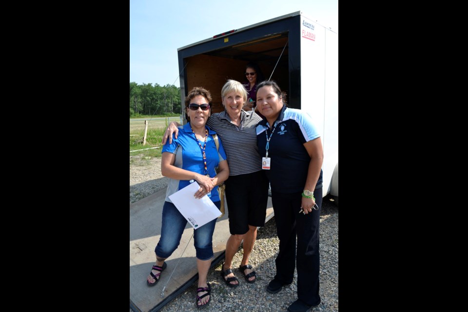 Janice Pelletier (left) and Teagan Littlechief (right) of the Bear Claw Casino accept a donation from Elaine Porter of Uxbridge, Ontario, on behalf of herself and her sister, Wilma Lothian of Carlyle. Porter said, “We heard about the Casino's fire relief campaign on the radio. You always hope that if you were in a situation like that, somebody would help you out.”