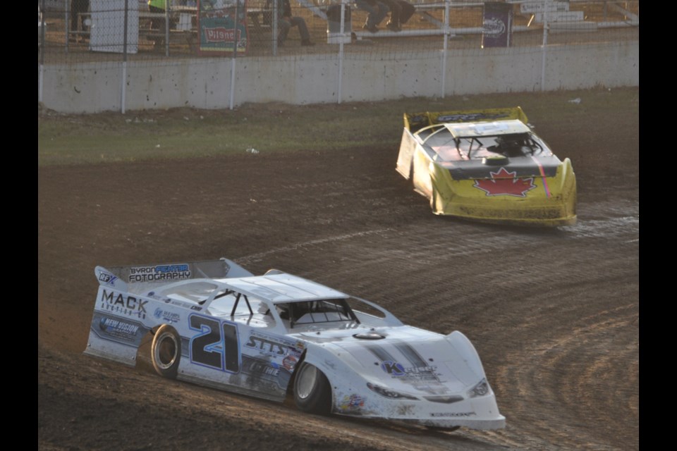 Aaron Turnbull (21) takes a corner with his brother Tyson in close pursuit in a summer late model heat.