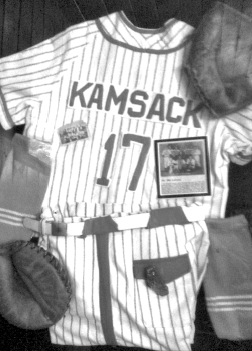 This display of Albert Cottenie’s baseball memorabilia, which includes his uniform, gloves and team photograph, was created by members of his family.