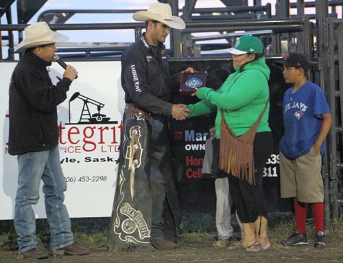 Vanessa BigEagle presented the Bear Claw Casino Champion Buckle to this year's Manor Fun Daze PBR winner, Aaron Roy of Yellowgrass.