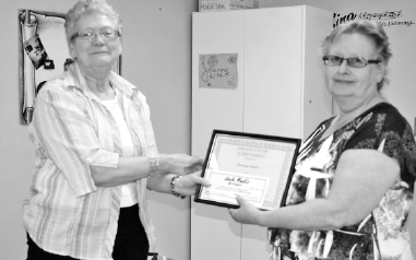 Jackie Blotski presented Darlene Mack (right) with an award for 15 years of service and another for her retirement at the Preeceville Mackenzie Society annual general meeting on June 18.