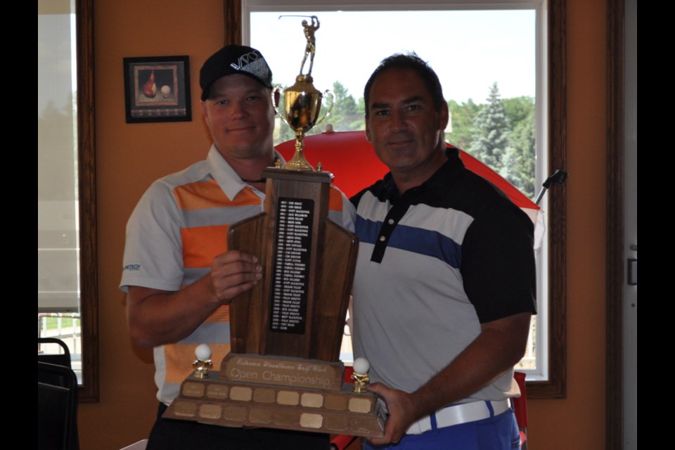 FrameTech Systems owner Brad Wilhelm; left, presents golfer Scott Allan with the Estevan Woodlawn Golf Classic Open Championship trophy last Monday after Allan shot a club record 63 in the final round of the Open to win.
