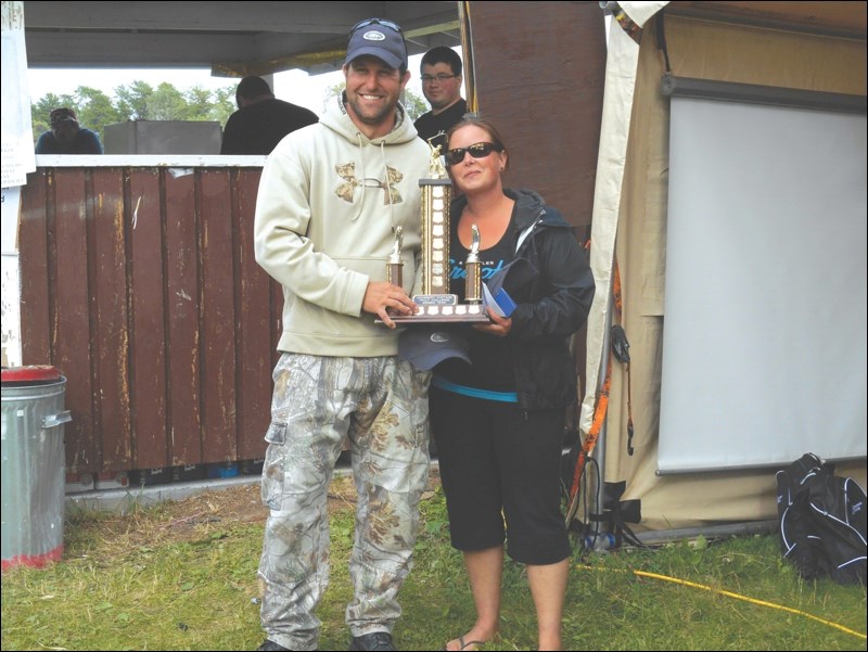 First place winners Jeff Chuchmuch and Danielle Thomas celebrate with their trophy; the pair also earned a $3,500 cash prize. Danielle Thomas also won the Candace Danielson Memorial Trophy, awarded to the woman who brings in the largest trout (Thomas’ catch was 33”); Chuchmuch won the prize for the largest fish caught on Saturday, a 42.75-inch trout.