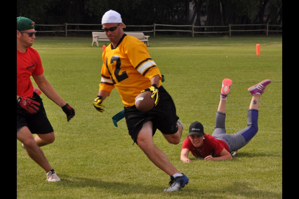 Intercepticons corner back Dylan Turner tries to capture Wil-Tech Warriors receiver Dean Nicklin's flag after he danced around linebacker Amy Harker to gain a few extra yards.