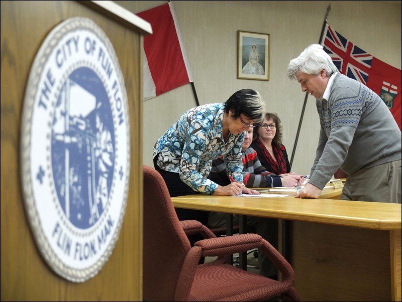 Beck is sworn in as a city councillor by Mark Kolt, chief administrative officer of the city, in November 2014.