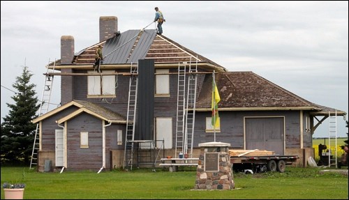 Dwaine Goller and Troy Moore re-roofing the Rabbit Lake and District Museum.