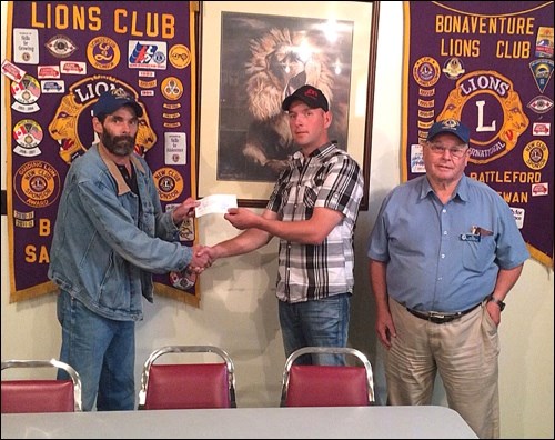 John Schempp of Maidstone is presented with $5,000 by project chair Lion Rod Russell and club president Cecil Russell.
