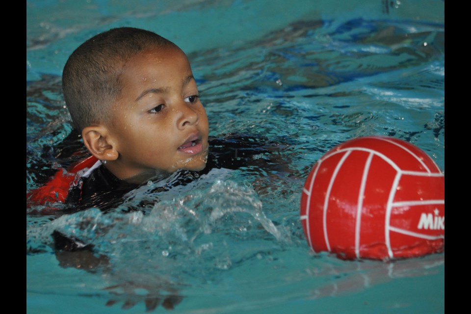 Young swimmer Carson Mvula attempts to transport a ball from one end of the pool to the other during the Estevan Sharks water polo club free trial clinic Aug. 26 at the RM of Estevan Aquatic Centre.