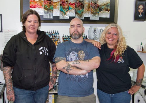 Vivid Crystal Tattoo Studio and Shoppe hosted guest artist Caleb Morgan (centre) of Elysium Tattoos in Florida and Connecticut. Here Morgan is joined by Sarah Dixon (left) and Crystal Begin (right) of Vivid Crystal in Stoughton.