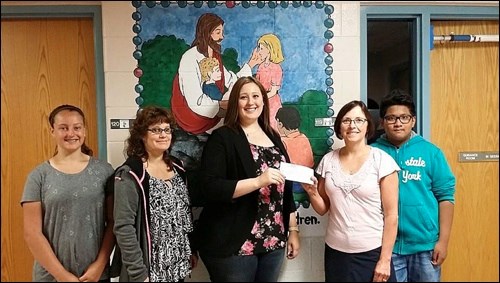 A donation is made to The Lighthouse. Photos submitted