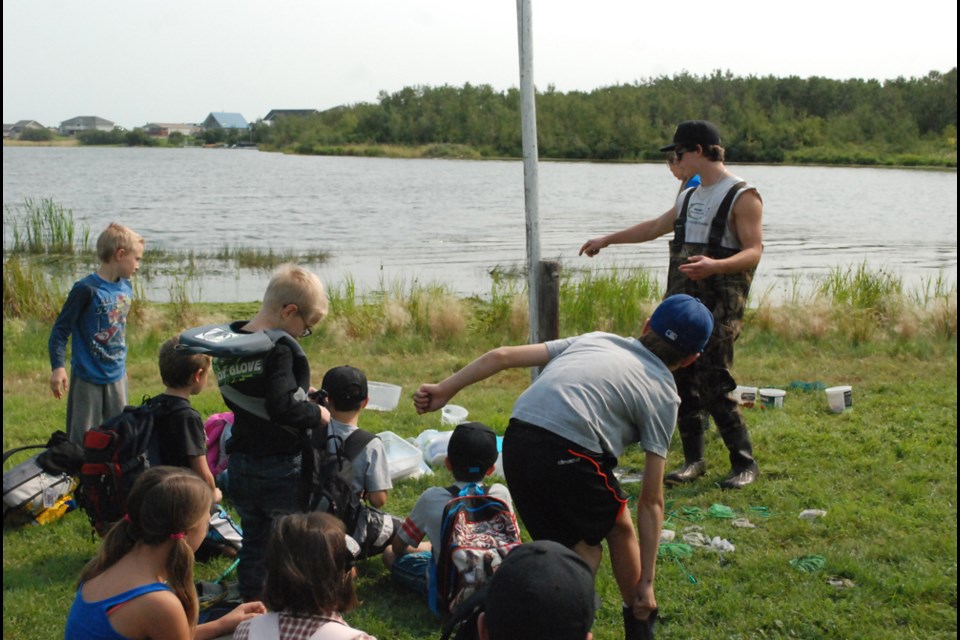 Dawson Atamanchuk gets the kids ready to critter dip.