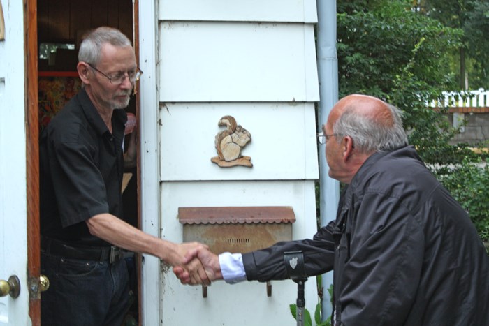 NDP candidate Doug Ottenbreit, right, shakes hands with a voter while door-knocking in downtown Yorkton September 5.