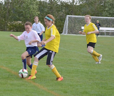 Alli Lytwyn (second from right) and Joie Simon (right) in the Players of Distinction game for girls. Joie scored one of the goals as the game ended in a 2-2 tie.