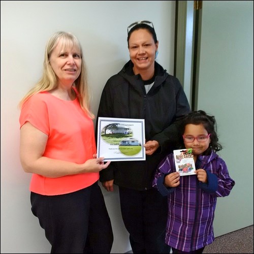 Grand Prize Winner Tracy Antoine (right) and her daughter Bronte are congratulated by NBHA Tenant Relations Officer Pat Derksen.