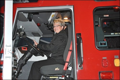 Battleford Town Administrator Sheryl Ballendine had a chance to climb up to the driver's seat of Battleford’s new half-million dollar fire engine when the vehicle was brought around to Town Hall during Monday evening’s town council meeting. Ballendine, having just officially announced her impending retirement, was encouraged to sound the siren. Photos by Jayne Foster