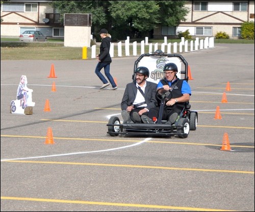 The SIDNE vehicle has arrived for the Battlefords Union Hospital Foundation’s PARTY program aimed at youth drivers. The idea is to simulate the effects of drinking and driving in a way that drives the point across to students about the consequences. Driver Walter Houk and passenger Roger Anderson took a test-drive on SIDNE and had a particularly tough time, especially on the third lap around the obstacle course when they were losing control of the vehicle and struggling to keep it on the road. Photos by John Cairns