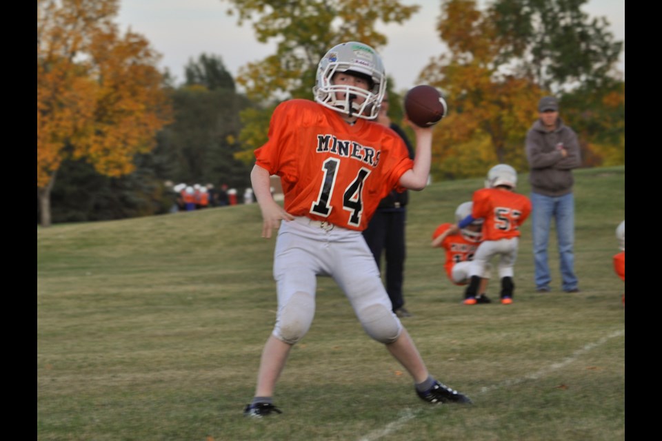 Miners quarterback Jacksen Hansen launches a pass.