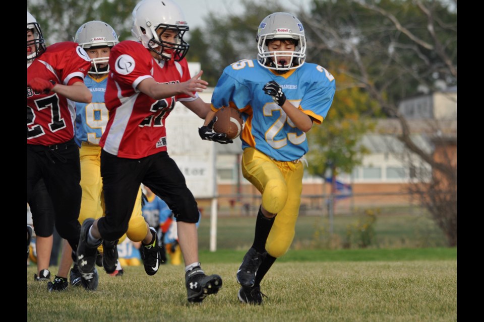 Chargers running back Keegan Merriman tries to elude a Eagles defender during the first half of Weyburn's 32-0 home win over Estevan last week.