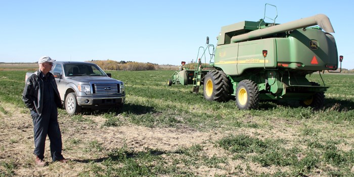 Vern Brown watches as crop going to the Yorkton Terriers is harvested on land he has helped provide.