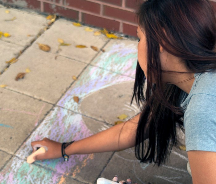 Persistence of Chalk Grade 8 students from Dr. Brass School practice recreating their favourite Aboriginal painting on school grounds before adorning the Godfrey Dean Art Gallery’s cement pad every autumn. Featured here are the students from Leah Murphy’s 7 & 8 Art classes recreating masterpieces on Friday afternoon. The drawings are a part of the Culture Days Initiative throughout Canada to raise awareness of the culture industry as well as the benefits of culture in communities.