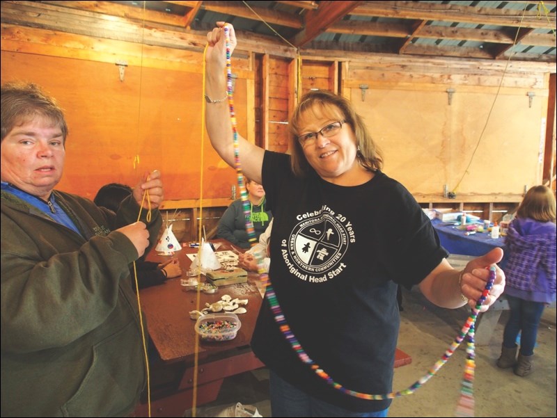 Katie Kawerski holds the “friendship chain” at the Rotary Wheel events. Guests entering the Wheel were invited to add a bead to the chain.