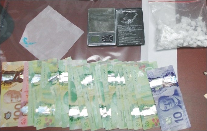 Powder cocaine (upper right), cash and other items seized in the bust.