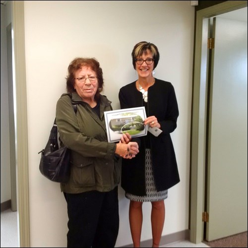 North Battleford Housing Authority Yard Pride Contest grand prize winner Arlene Ahenakew is congratulated by Operations Manager Cheryl Cook-Taylor. Photos submitted
