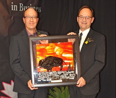 Business of the Year went to Discovery Co-op. Battlefords MLA Herb Cox made the presentation on behalf of SaskTel to board president Randy Graham. Photos by John Cairns