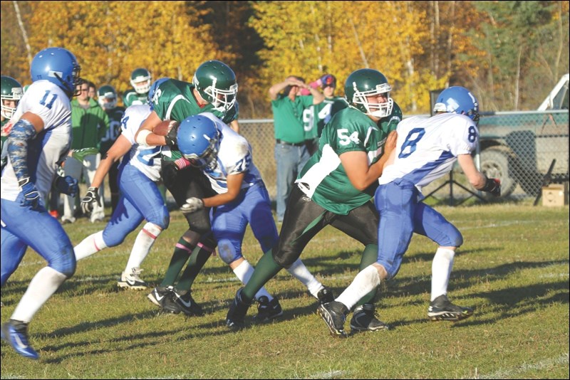 Tight end Josh Nowlin (with ball) and offensive lineman John Gardiner of the Creighton Kodiaks attempt to battle past the La Ronge-Churchill Chargers last week. The Kodiaks now play in both the league final and, for the first time, the provincial playoffs.