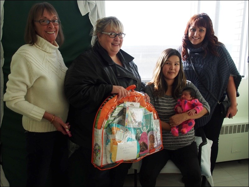 Members of the Baby Friendly Initiative Committee presented Flin Flon’s first October baby with special gifts to mark World Breastfeeding Week.  Pictured (left to right) are committee members Carol Hydamaka of Best Beginnings Baby & Me, Shelly Vancoughnett of Kids First North, mom Carla Roberts of Pelican Narrows with daughter Carly Cook, and Kelleen Blouin of Kids First North. Carly Cook was born early in the morning on Oct. 1 weighing six pounds, eight ounces.