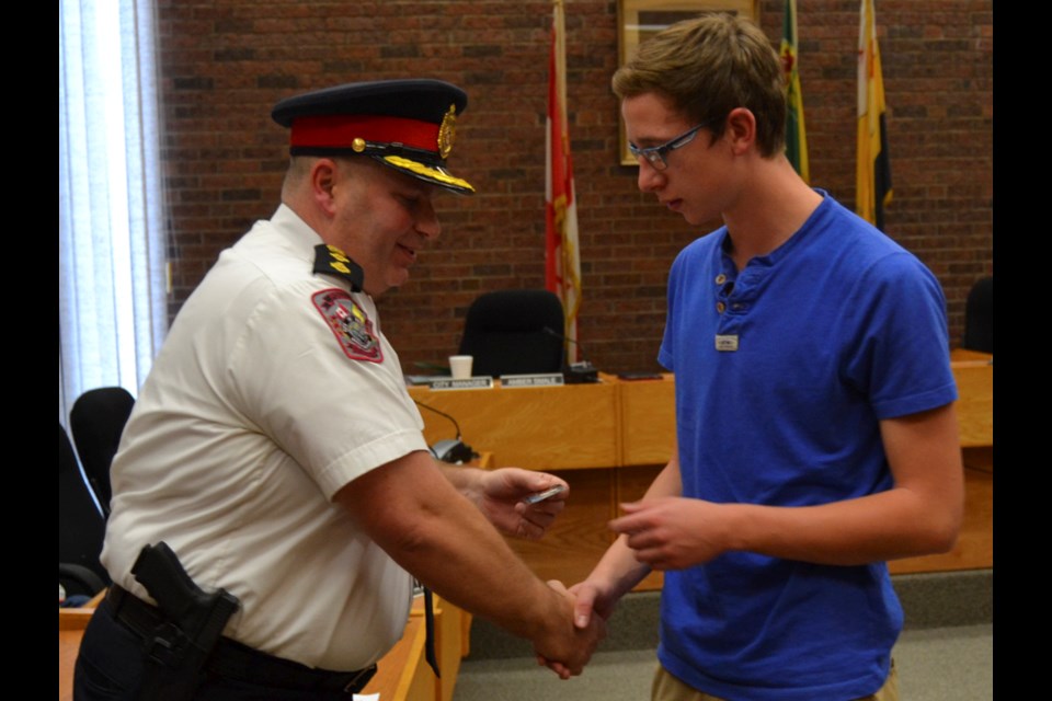 Colin Sutter was one of four youths to help victims of a head-on collision on Kensington Avenue, on Oct. 10. He, and the others who helped out were awarded challenge coins on Oct. 16, at a police board meeting.