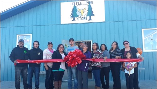The staff of Little Pine Store with manager Vanessa Fox (far right) and her daughter Cassidy prepare to cut the ribbon on a new store building. Photos submitted