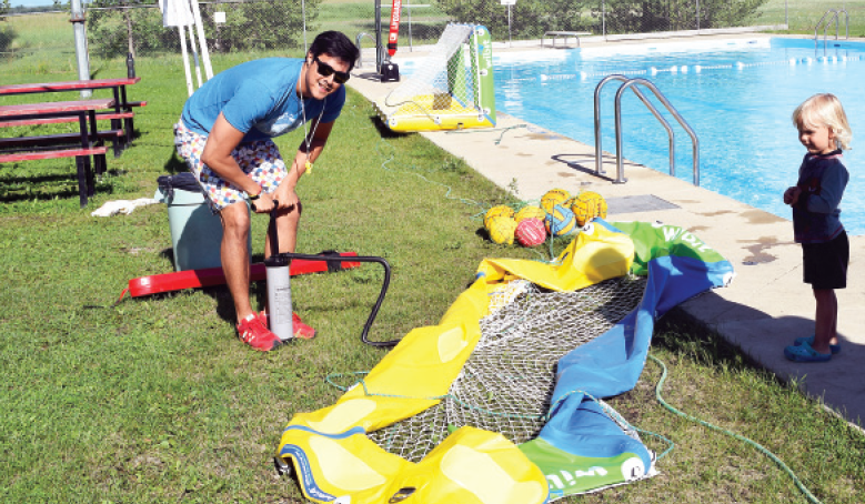 Inflatable goals, which are an essential component of water polo, were infl ated by Victor Bautista of Water Polo Saskatchewan on Friday when he conducted a session on the sport in Kamsack. Offering his assistance at right was Kayman Nikoforoff