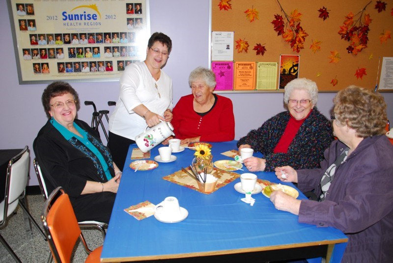 Serving coffee Lorie Wasyliw (president of the Hospital auxiliary) served coffee to guests (from left) Nettie Okrainetz, Pat Bellay, Veronica Dutchak and Evelyn Dutchak.