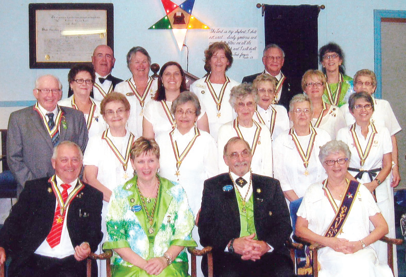 Officers of Hiawatha Chapter of the Order of the Eastern Star were photographed recently with the worthy grand matron and patron. From left, were: Roderick and Ruby Lee of Foam Lake, Sally Bishop of Kamsack, David Polachek of Yorkton and Milena Hollett of Kamsack; (third row) Nancy Leson of Canora, Angela Bothner of Yorkton, Patricia Polachek of Yorkton, Kathy Gordon of Yorkton and Maxine Greiner of Yorkton; (second row) Earl Greiner of Yorkton, Mary Welykholowa of Kamsack, Kathleen Achtymichuk of Kamsack, Ellie Kilmister of Kamsack, Vicky Tanton of Stenen and Susan Bear of Kamsack, and (front) Stan Stone of Kamsack, worthy patron; Idella Barr of North Battleford, worthy grand matron; Eric Rann of Biggar, worthy grand patron, and Judy Stone of Kamsack, worthy matron.