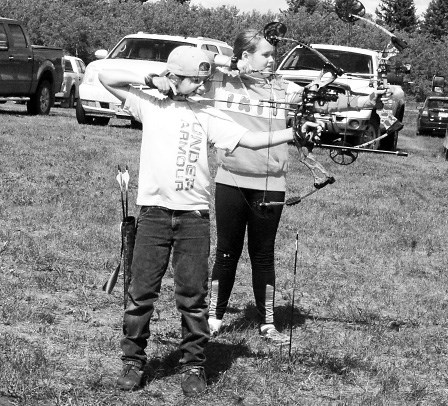 Evan Bochniuk, left, and Kylie Babiuk both took careful aim at the iron buck for a chance to win a prize at the 3-D archery shoot on August 15 and 16.