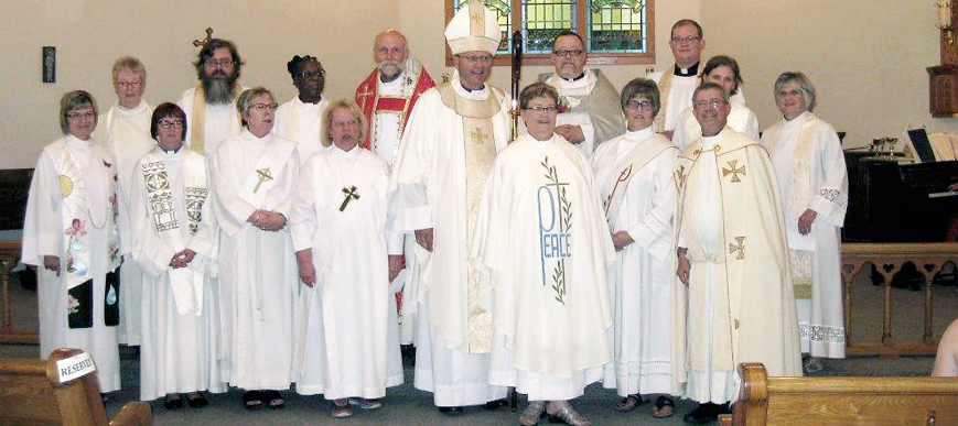 Rev. Nancy Brunt of Kamsack, who has been serving as a deacon in the Anglican Church of Canada, was ordained into the priesthood during special services at Holy Trinity Anglican Church in Yorkton on August 9 by Rev. Bishop Robert Hardwick, Bishop of Qu’Appelle. Included in the service were members of the Diocesan clergy including arch deacons, priests and deacons. In the photo, Brunt is standing immediately to the front and left of the bishop at centre.