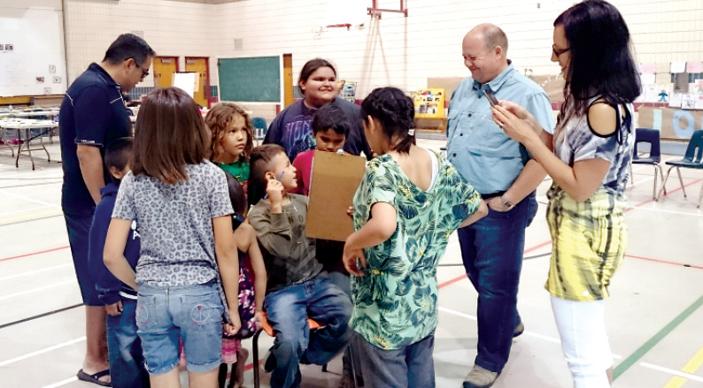 Among the adults who were involved with the children in a three-week literacy camp at Cote First Nation this summer, from left, were (standing) Corey O’Soup, assistant deputy minister of Aboriginal and Métis affairs; Kevin Fenwick, deputy minister of justice, and Rhonda Taylor, regional manager of Frontier College in Manitoba and Saskatchewan.