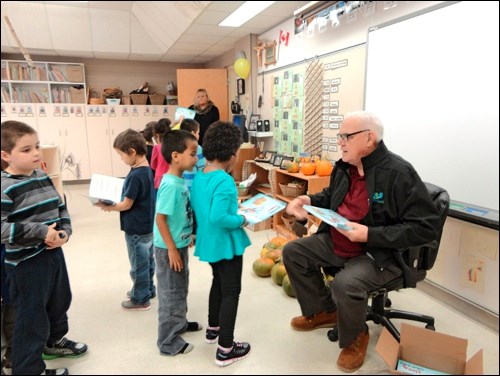 Keith Koberinski presents the gift of "I Love My Catholic School", to each of the students he read to. The LOCCS Board purchased the books for presentation, in celebration of Education Week
