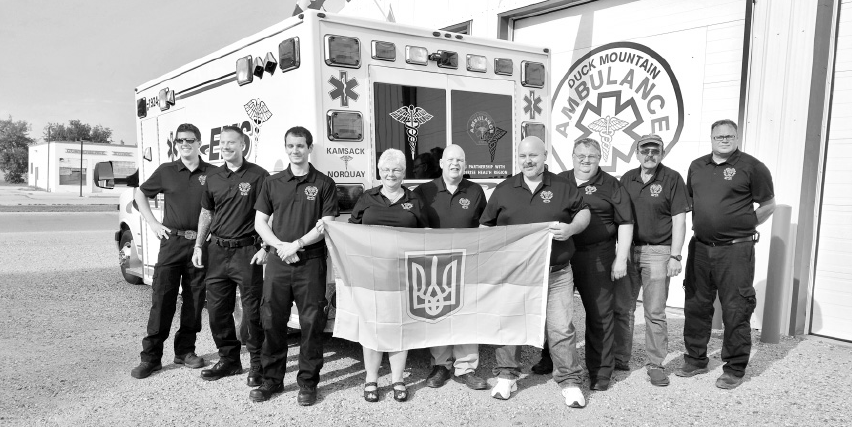 The staff of Duck Mountain Ambulance Care in Kamsack was photographed with a flag of Ukraine recently to mark the donation of an ambulance unit to Ukraine.