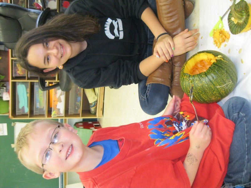 Jacob Lowes made sure his clothing was covered and protected when he began carving a pumpkin at the Canora Junior Elementary School last week. The Grade 1 student was partners with Megan Tomilin, a Grade 12 student, for this special art project.