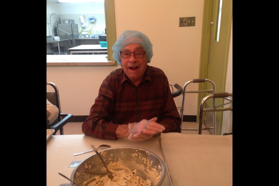 Dan Skea helped mix the dough for cookies that were baked at Eaglestone Lodge for the residents’ Halloween party.