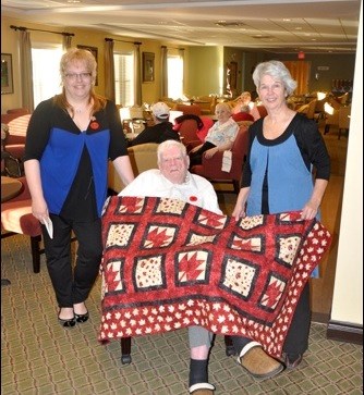 Jack Abbott, RCAF WWII, seen with Shannon McGilvery of Quilts of Valour and Kathy Kennedy of The Sewing Machine Store. Photos by John Cairns