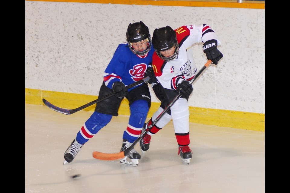 Hudsyn Nelson played hard to keep Canora players on the boards during the Atom Pats first game of the year in Canora on Sunday. The Pats won 10-1.