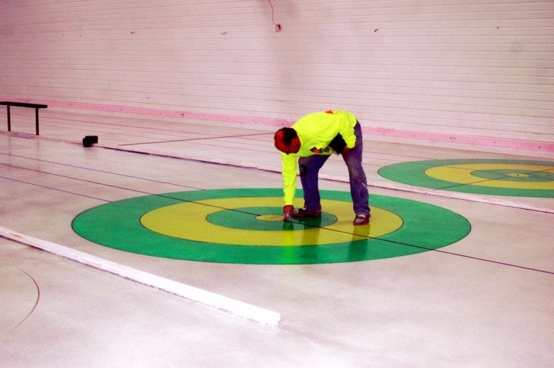 Sheldon Luciw, along with many other volunteers, helped to paint the circles for the new ice as curling season was scheduled to start November 12.