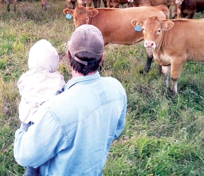 Brett Spray and his daughter Rebecca checked the
purebred Gelbvieh cattle in the pasture.