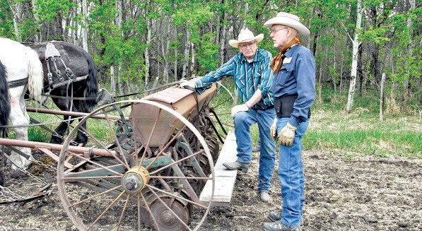 Lloyd Smith (left) of Pelly and Walter Hughes of Preeceville made sure the seed drill was ready to go on May 16 during the PALS Draft Horse Field Days
in Rama.