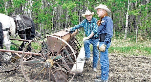 Lloyd Smith (left) of Pelly and Walter Hughes of Preeceville made sure the seed drill was ready to go on May 16 during the PALS Draft Horse Field Days
in Rama.