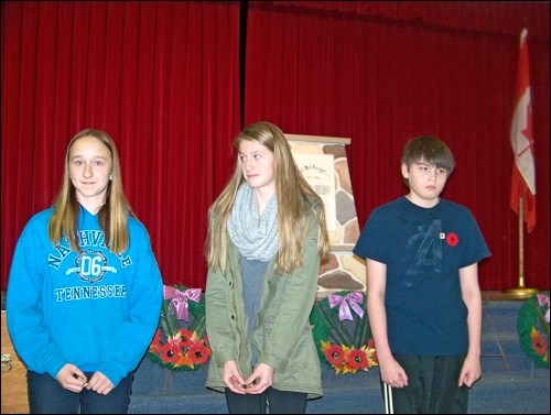 Peace poster winners receiving prize money at Borden's Remembrance Day Service  were  Angelaya Tracksell, Savannah Sutherland and  3. James Jamieson.