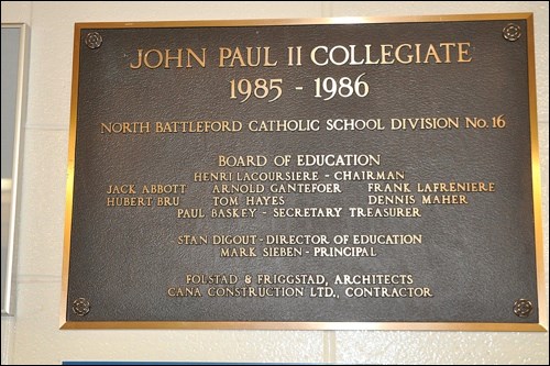 A plaque from the time of the renovation of the former NBCI into the present John Paul II Collegiate is found outside the door of the school office. Photos by Jayne Foster